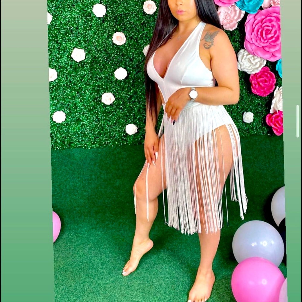 White one piece bathing suit with fringe.